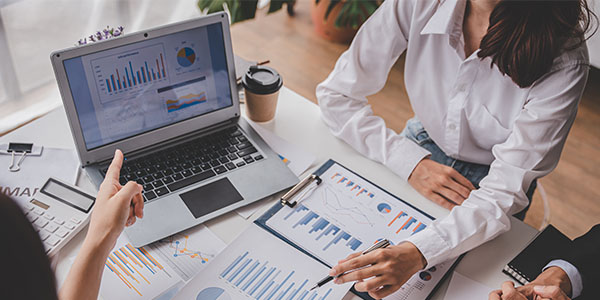 people meeting and discussing financial charts