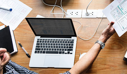 ux worker with laptop and sketch wireframe