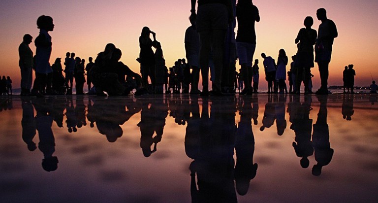 people gathered at sunset