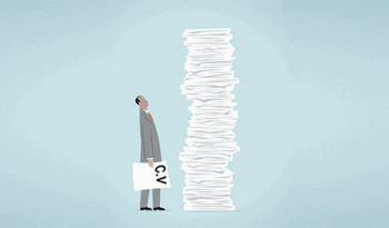 Person staring at a stack of paper.